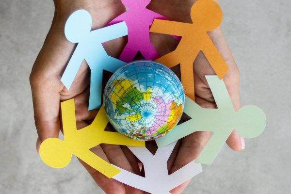 top-view-origami-chain-people-with-globe